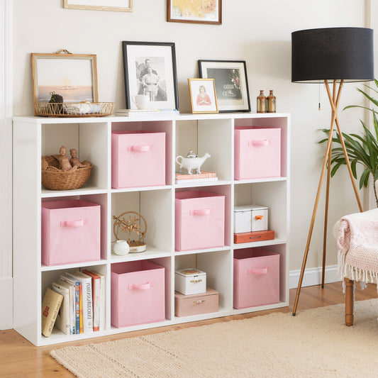 White bookshelf with pink storage boxes in a room setting.